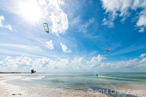 Kite surfers racing across the water in the calm shallow waters of Laguna Chacmuchuc.