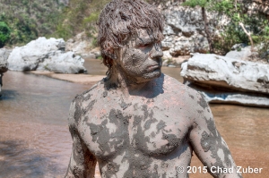 Primitive savage warrior covered in mud